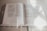Close-up of an open book with soft natural light highlighting the pages.