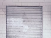 Industrial roller shutters protecting a warehouse, showcasing strength and security.