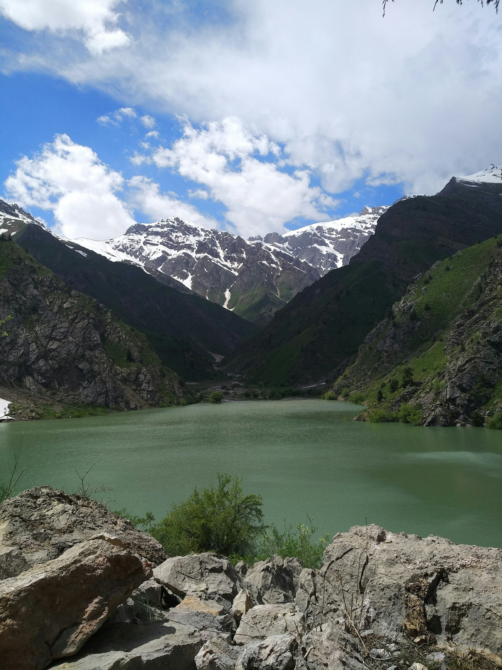 woman wearing yellow long-sleeved dress under white clouds and blue sky during daytime