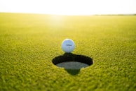 golf ball on green grass field during daytime