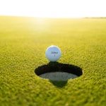 golf ball on green grass field during daytime