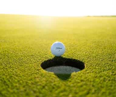 golf ball on green grass field during daytime