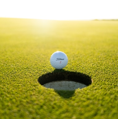 golf ball on green grass field during daytime