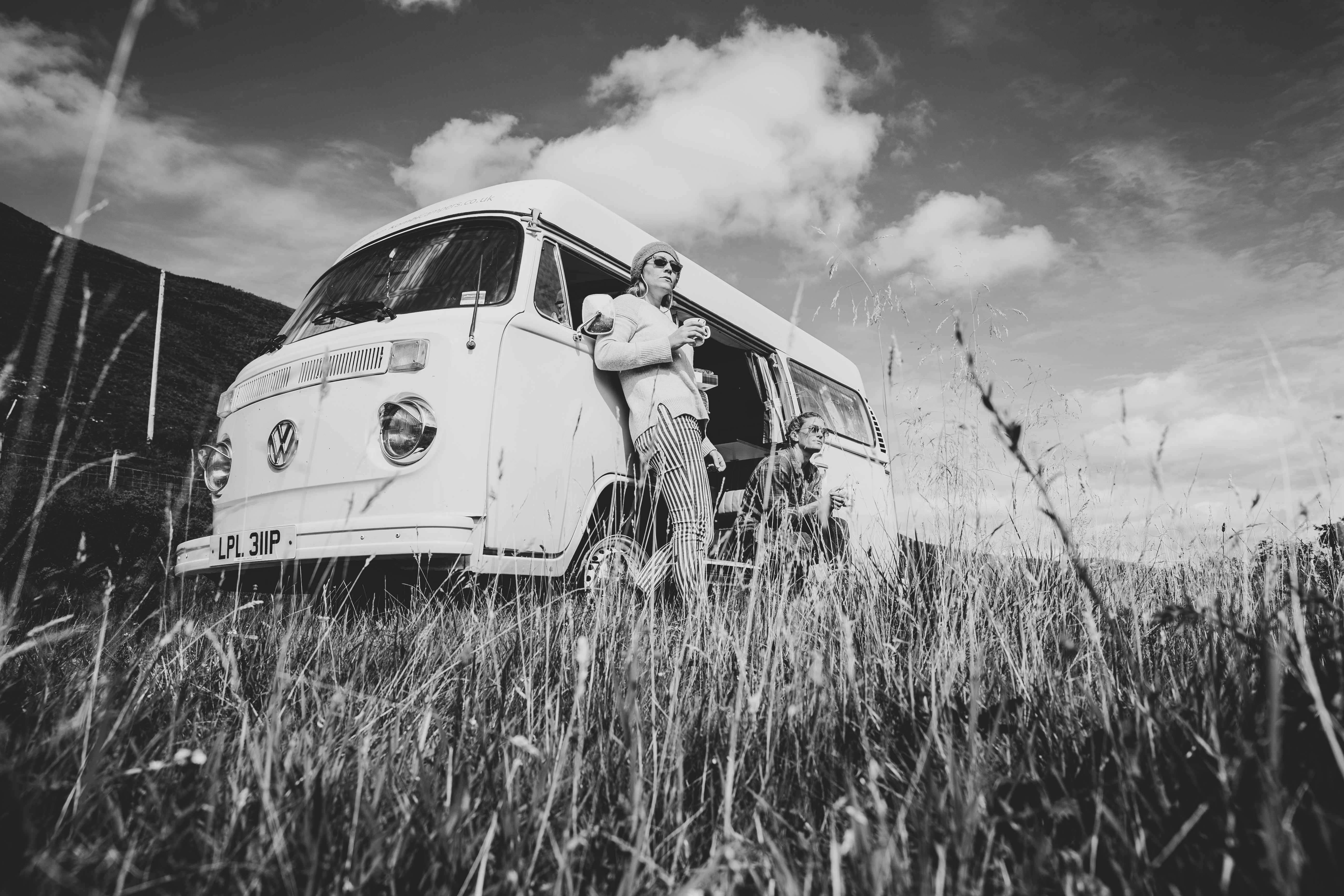 grayscale photo of man in car