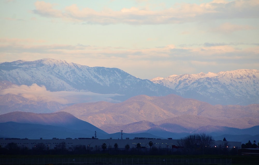 green grass field near mountains during daytime