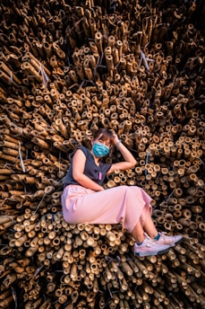 woman in purple dress lying on ground with brown leaves