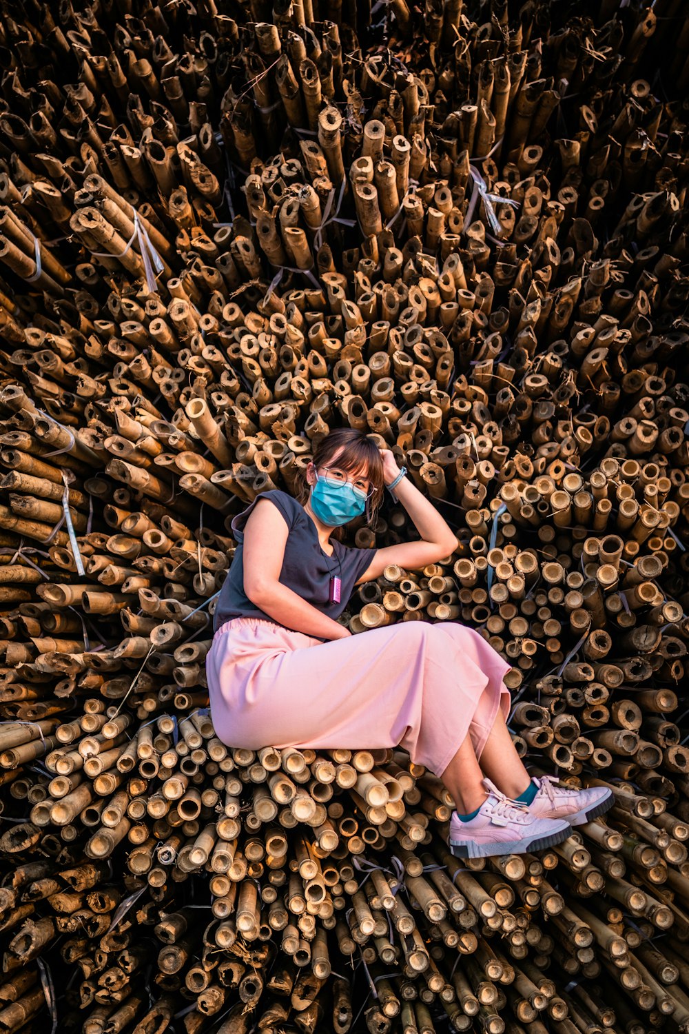 woman in purple dress lying on ground with brown leaves