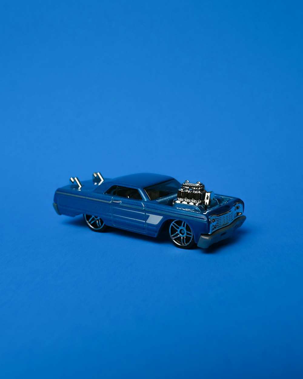 black coupe on blue background
