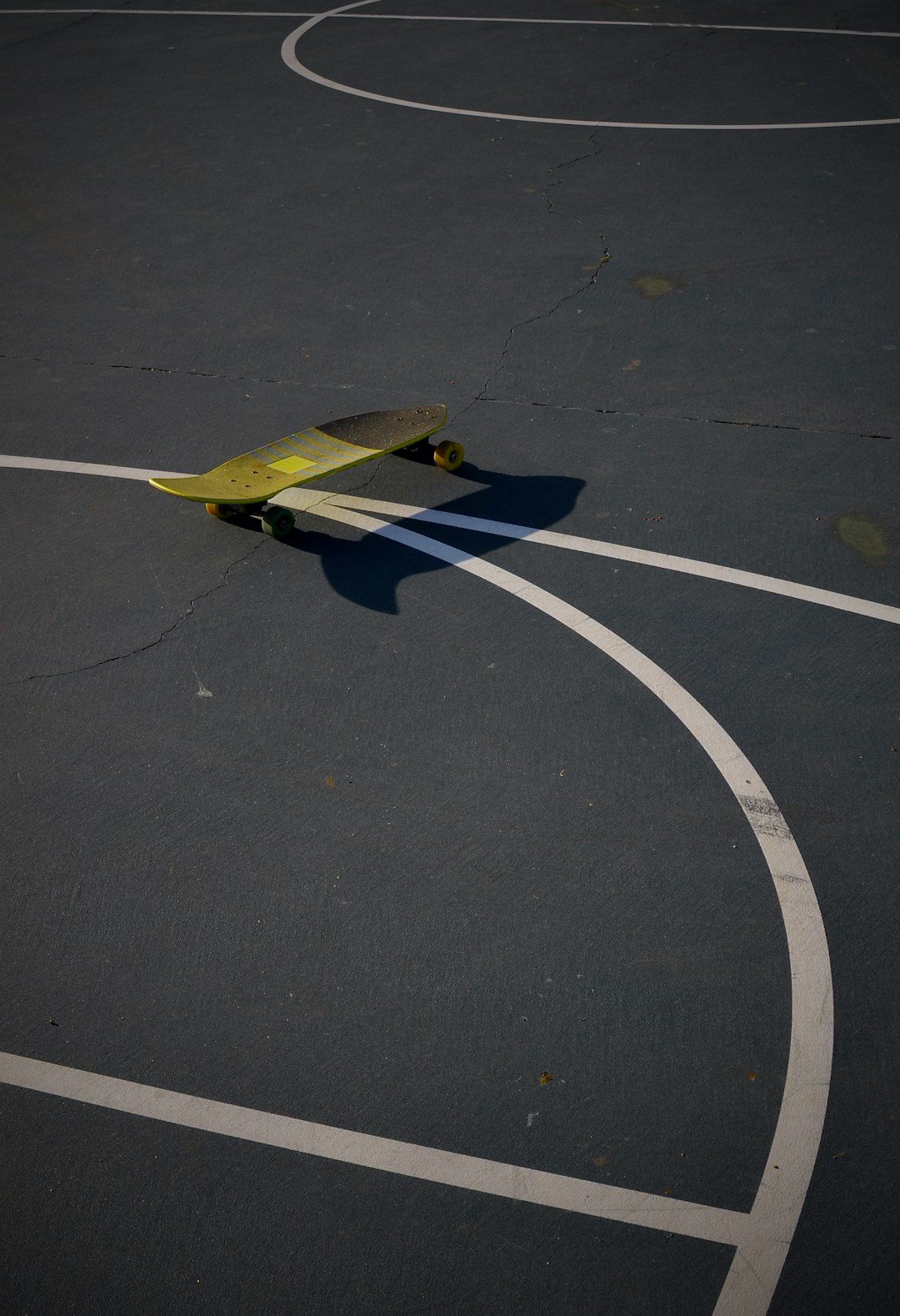 yellow and blue plane toy on black asphalt road