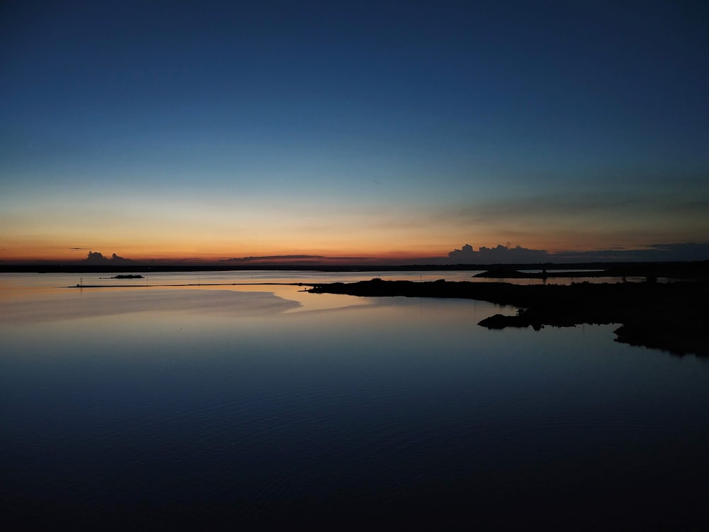 body of water during sunset