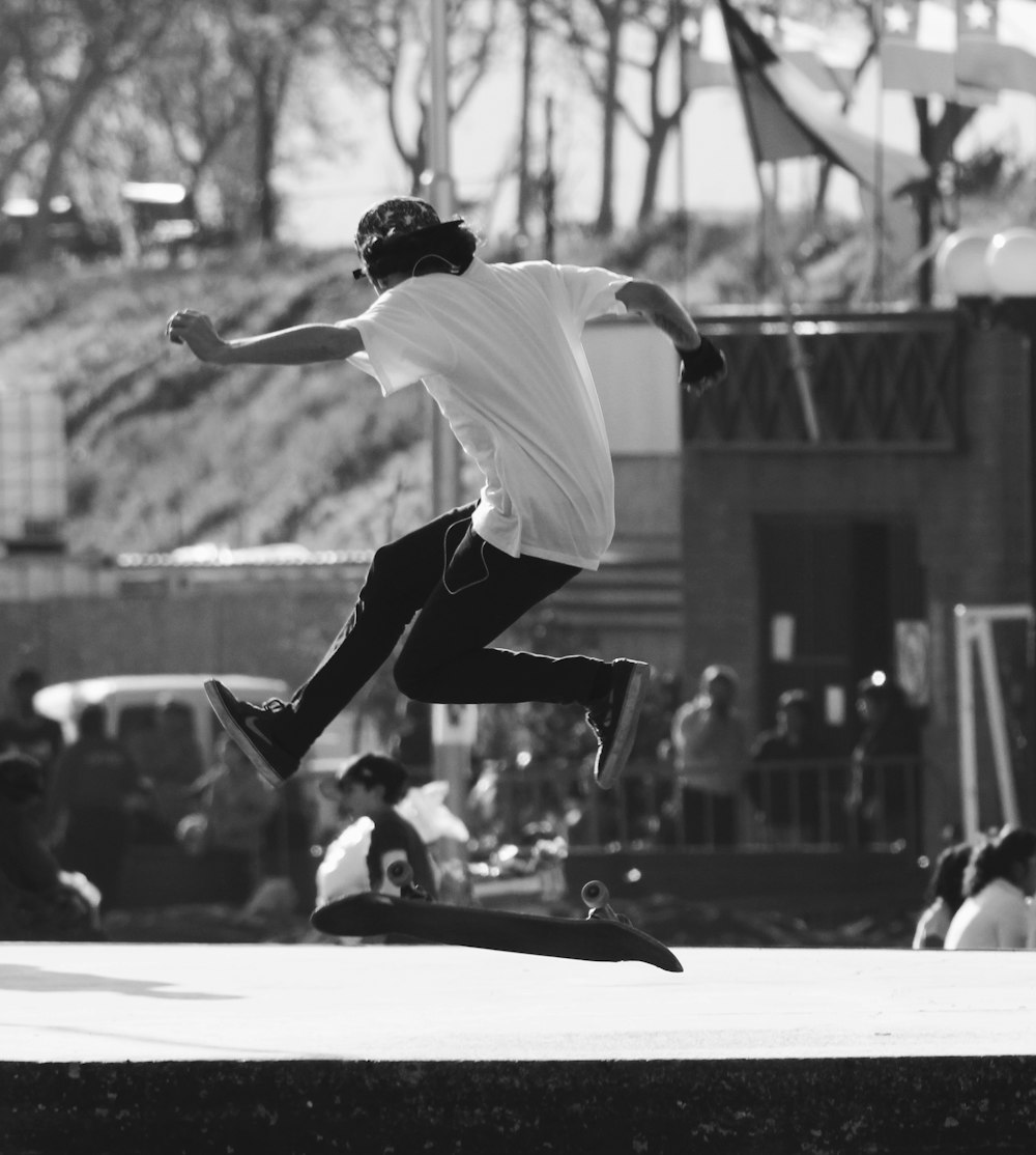 man in white shirt and black pants jumping on white floor