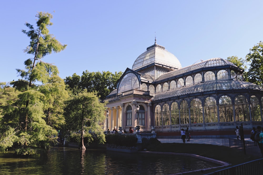 white and brown dome building near green trees and river during daytime