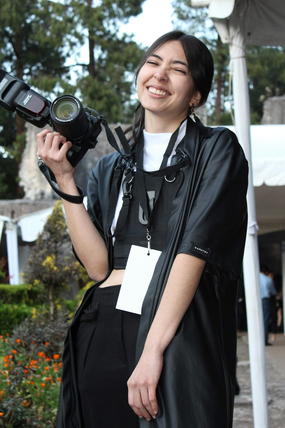 woman in black button up shirt holding black dslr camera