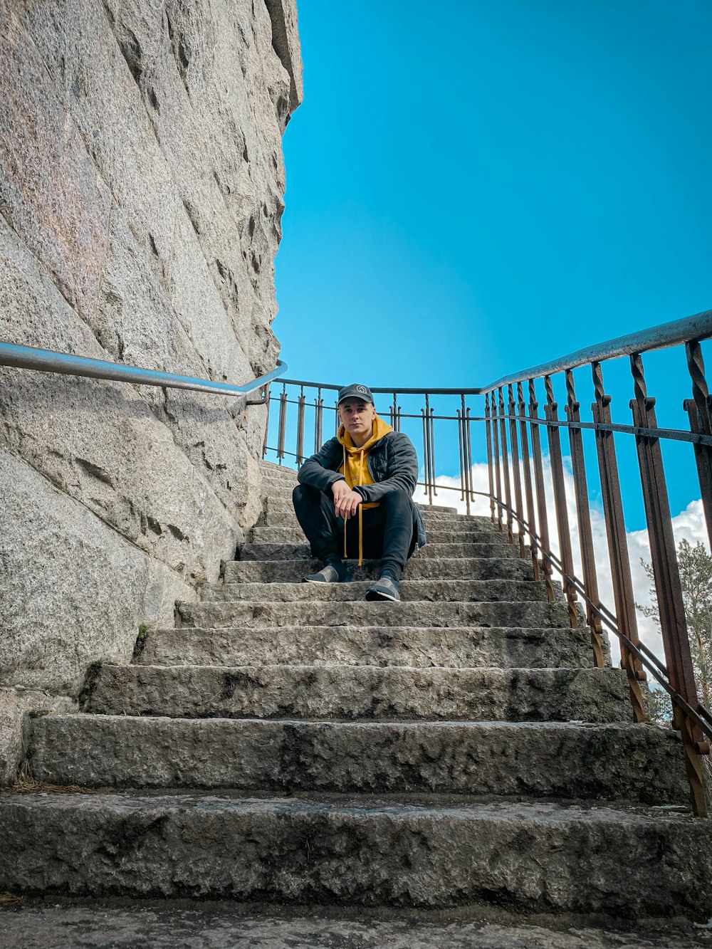 woman in black jacket sitting on stairs