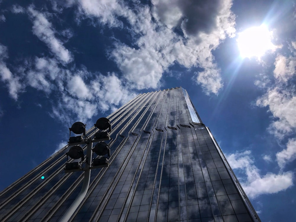 low angle photography of gray building under blue sky during daytime