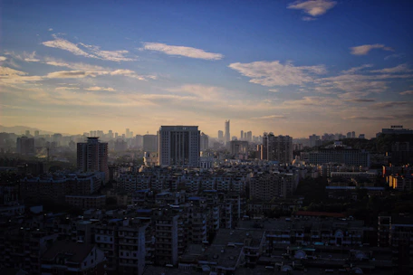 Vibrant cityscape view from a high-rise hotel balcony at twilight.