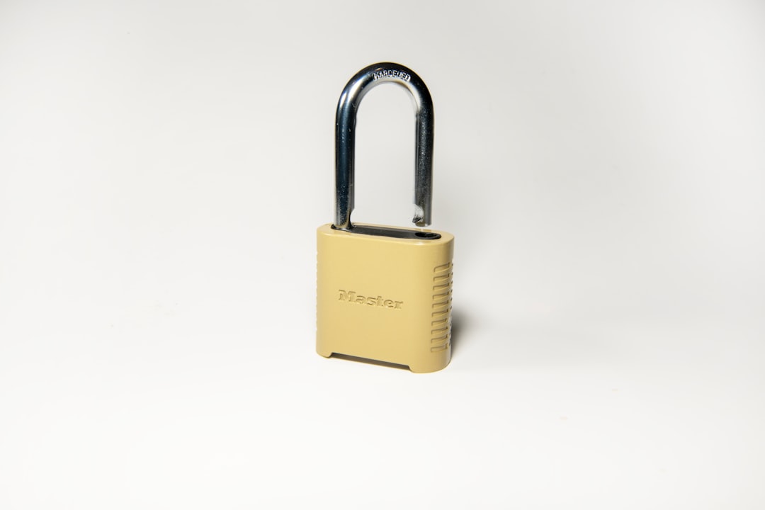  gold padlock on white surface lock