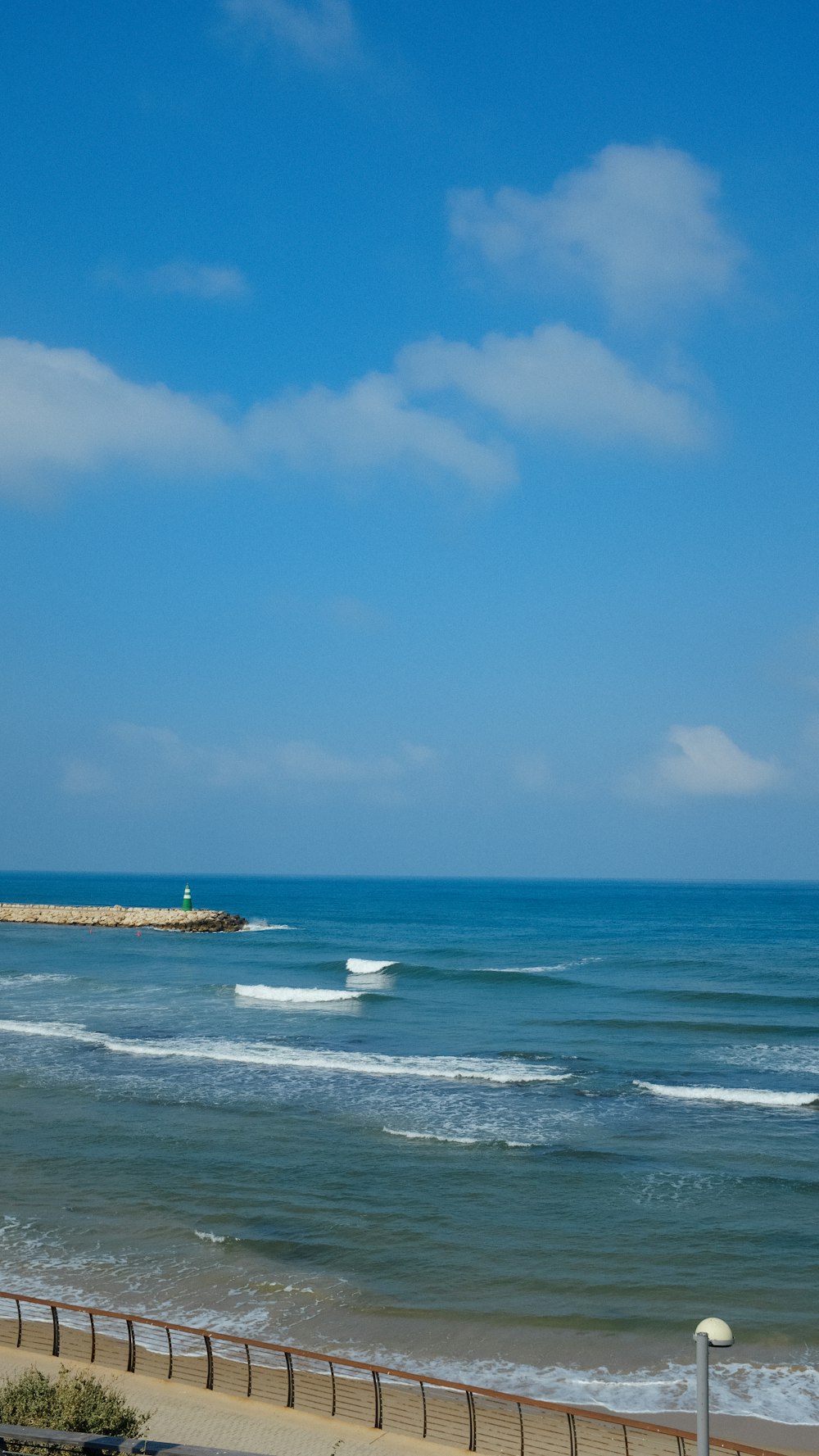 white boat on sea under blue sky during daytime