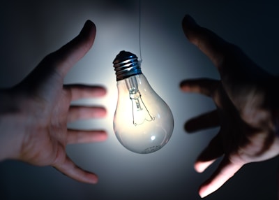 light bulb on persons hand