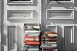 books on gray wooden door