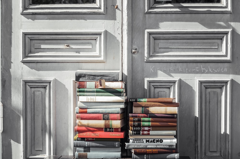 books on gray wooden door