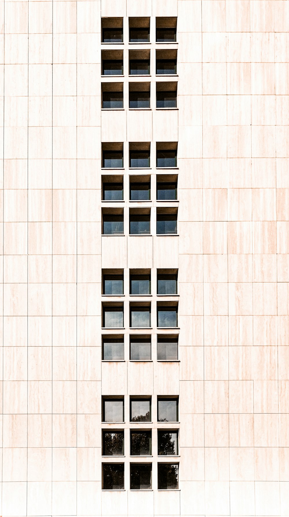 white concrete building with glass windows