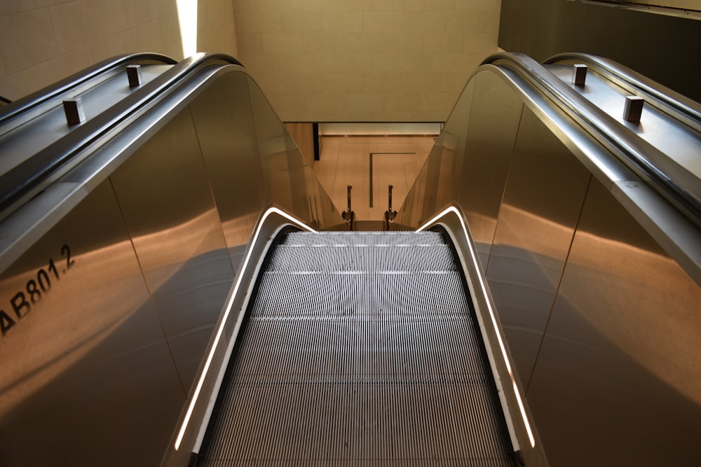 black escalator in brown tiled room