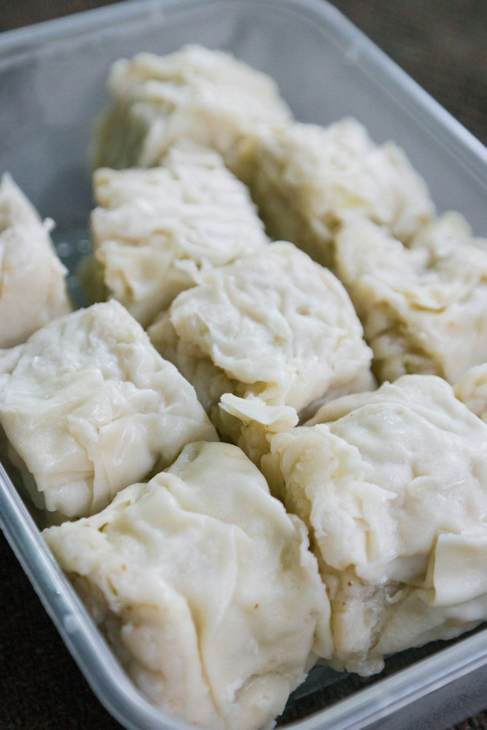 white dumplings on stainless steel tray