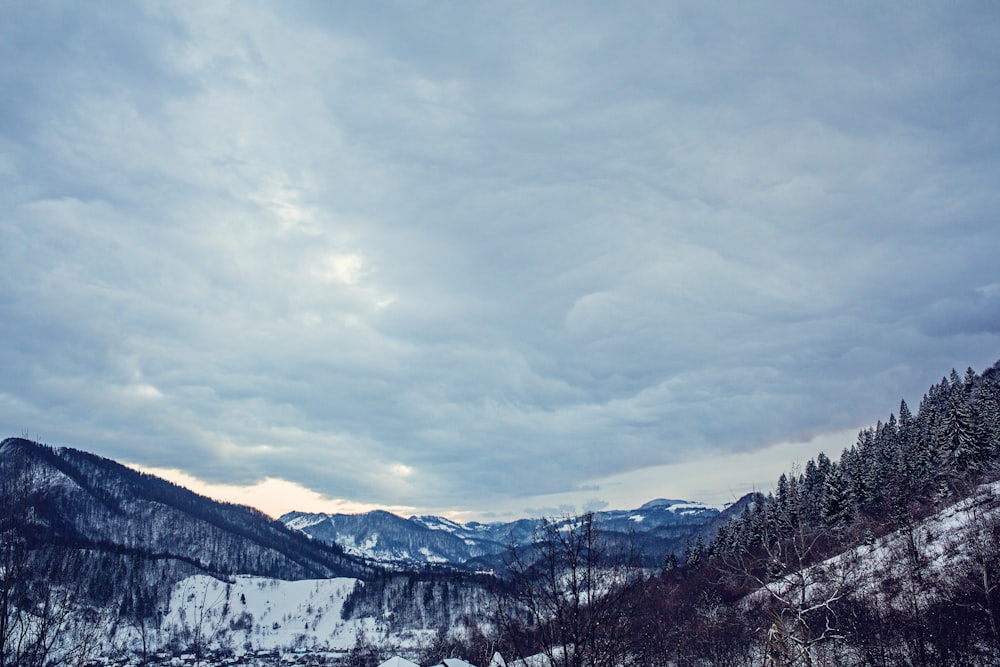 snow covered mountain under cloudy sky during daytime