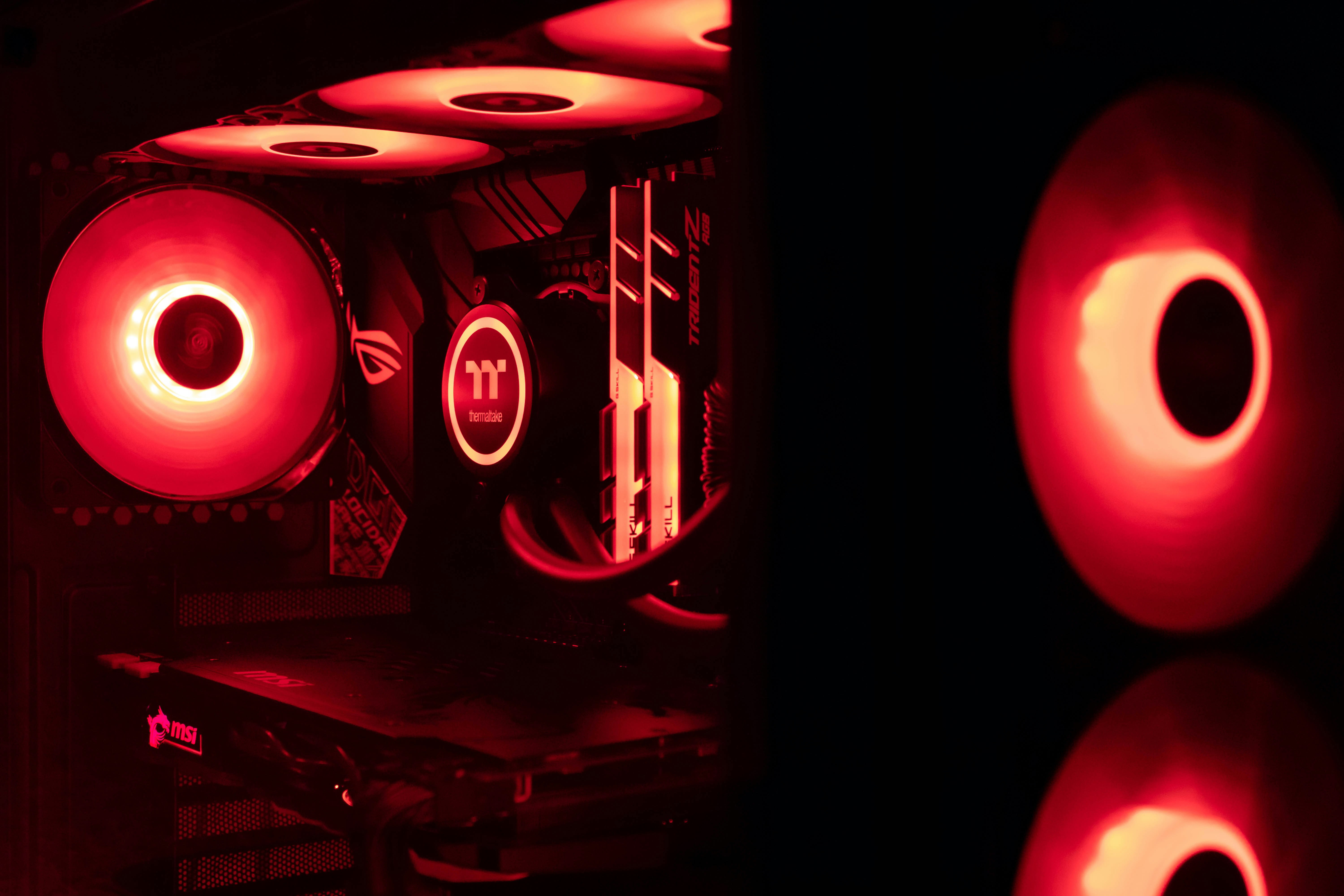 Inside of a professional watercooled gaming/workstation computer with red LED lighting