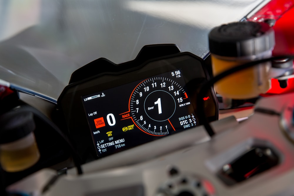 black and orange analog speedometer