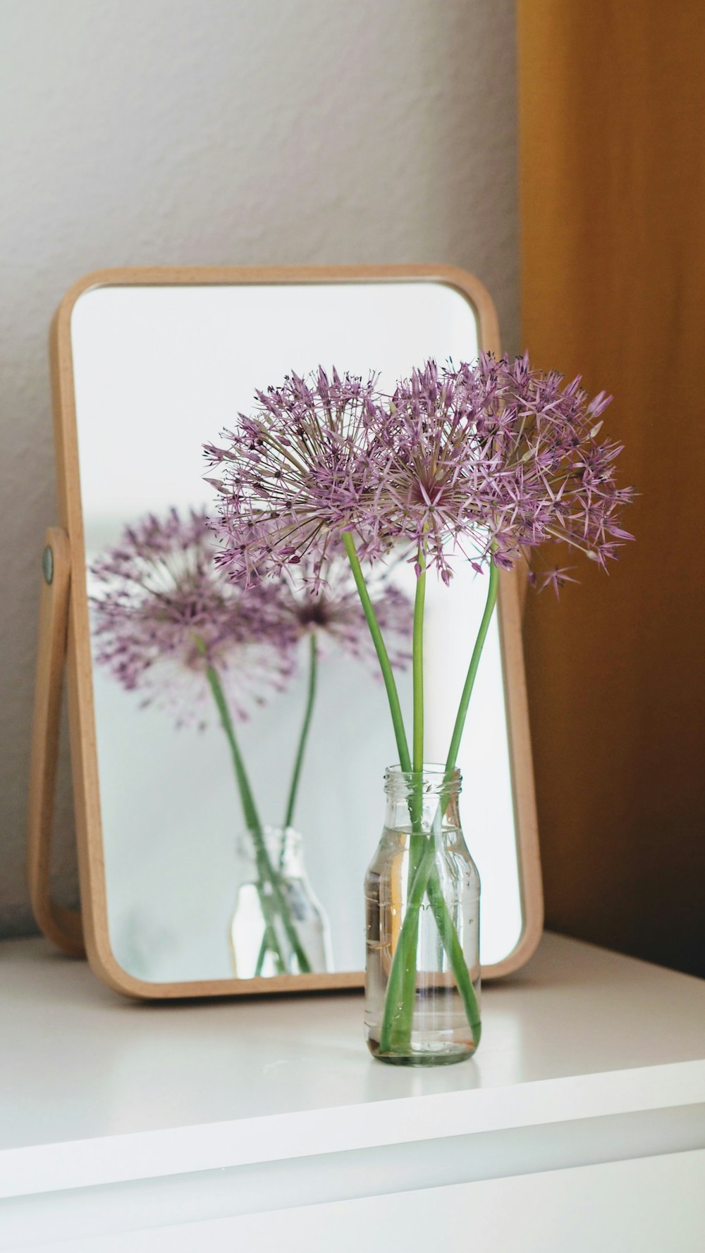 pink flowers in clear glass vase