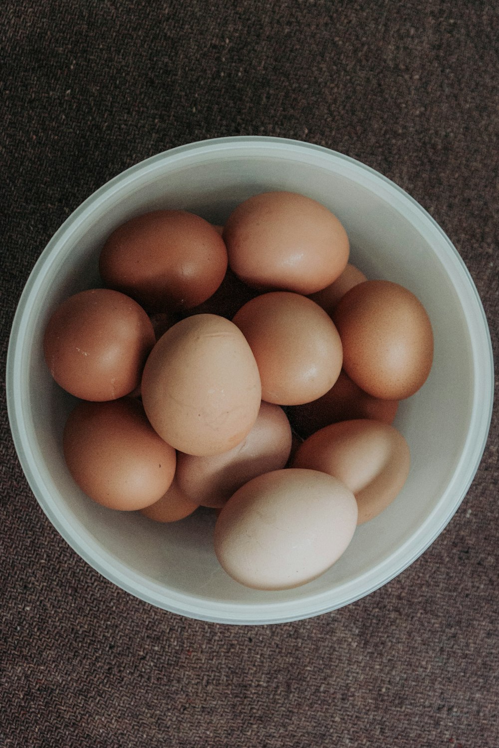 brown egg on white ceramic bowl