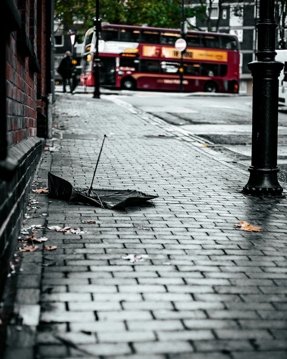 black umbrella on sidewalk during daytime
