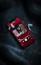 red iphone 5 c on black textile