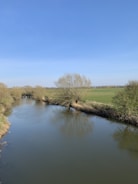 A clean river flowing through the rural landscape of Caldas.