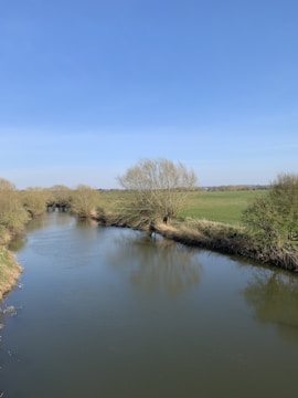 A clean river flowing through the rural landscape of Caldas.