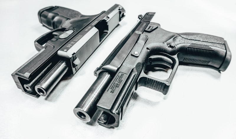black semi automatic airsoft pistol on white textile