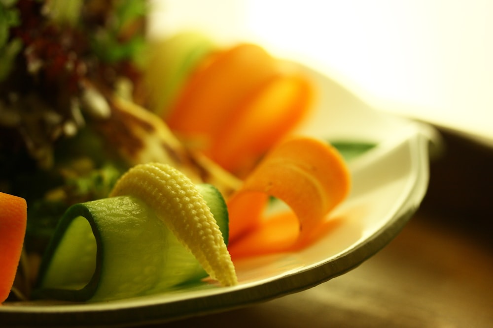 pepino en rodajas sobre plato de cerámica blanca