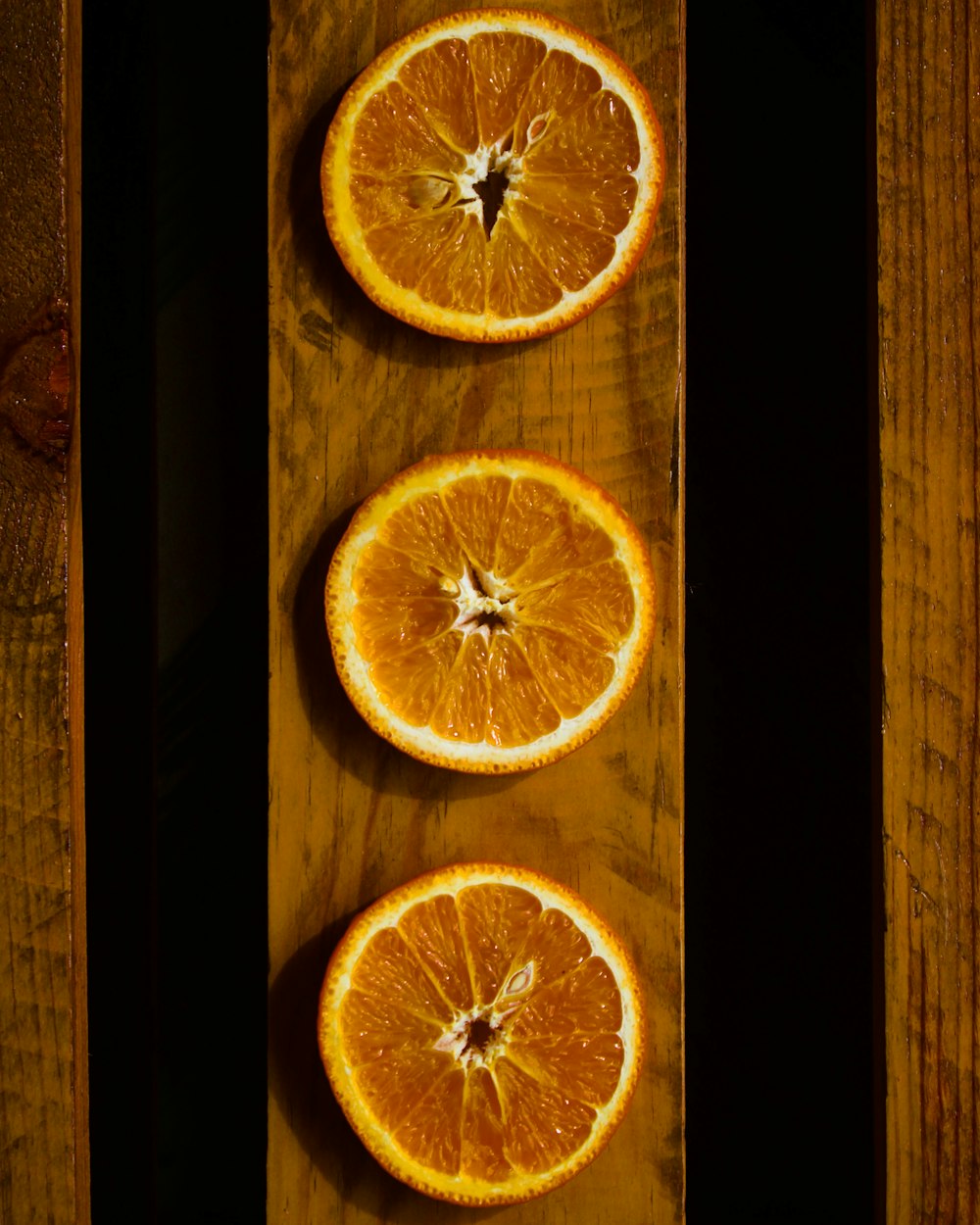 sliced orange fruit on black surface
