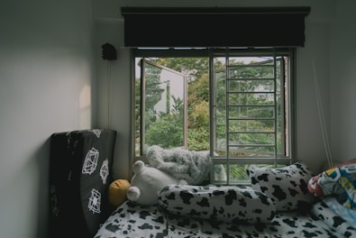 Comfortable bedroom with soft linens and a peaceful countryside view.