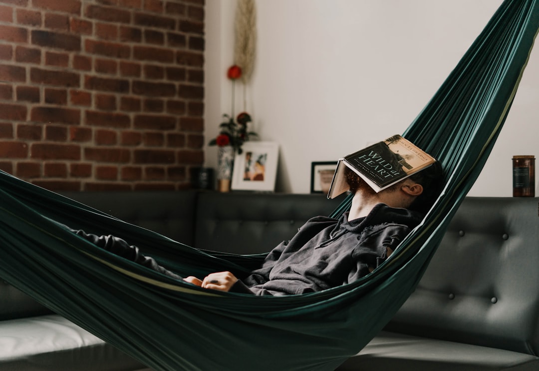 woman in black hijab reading book