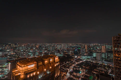 A sleek, glowing cityscape bathed in neon lights under a starry sky.