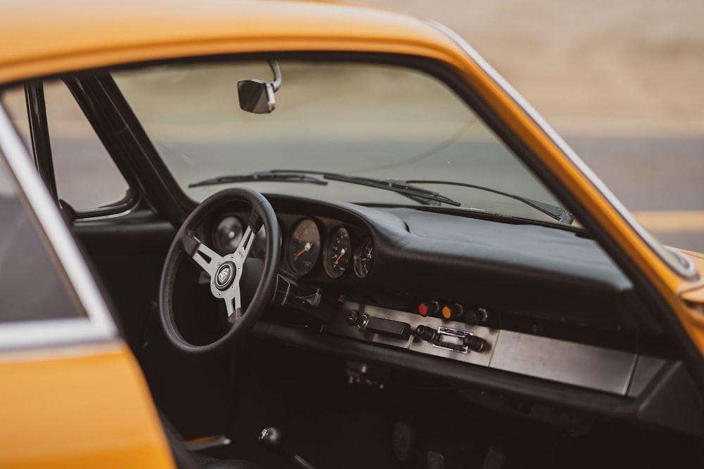 black and orange car steering wheel