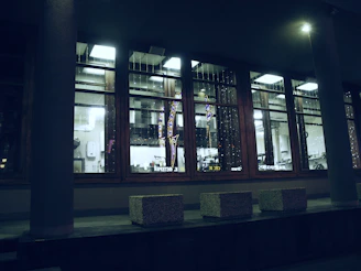 Exterior view of l’alchimiste restaurant at dusk with warm glowing windows