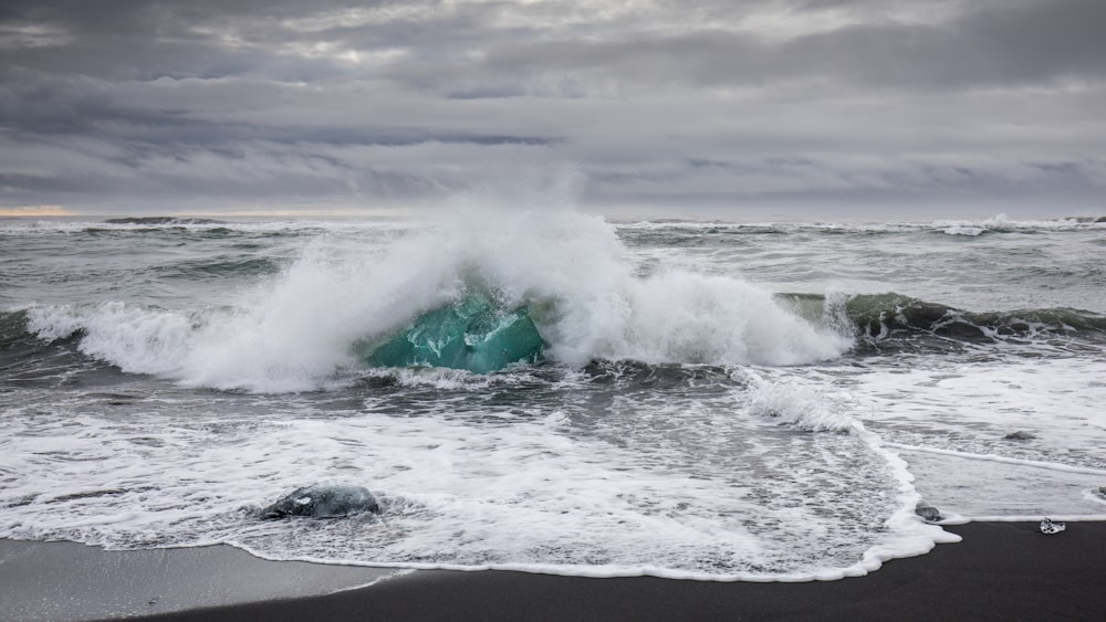 ocean waves crashing on shore during daytime