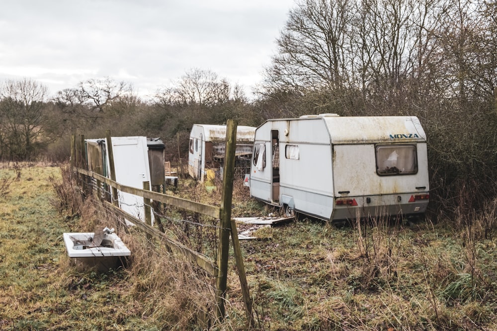 white rv trailer on green grass field during daytime