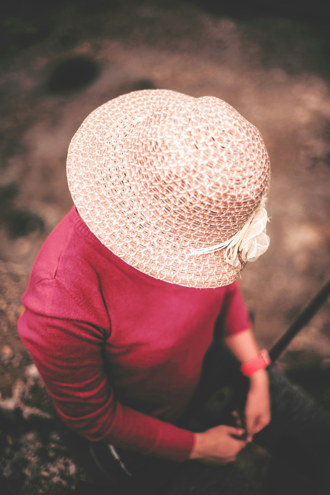 woman in red long sleeve shirt wearing white knit cap