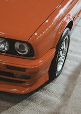 orange car on gray concrete floor