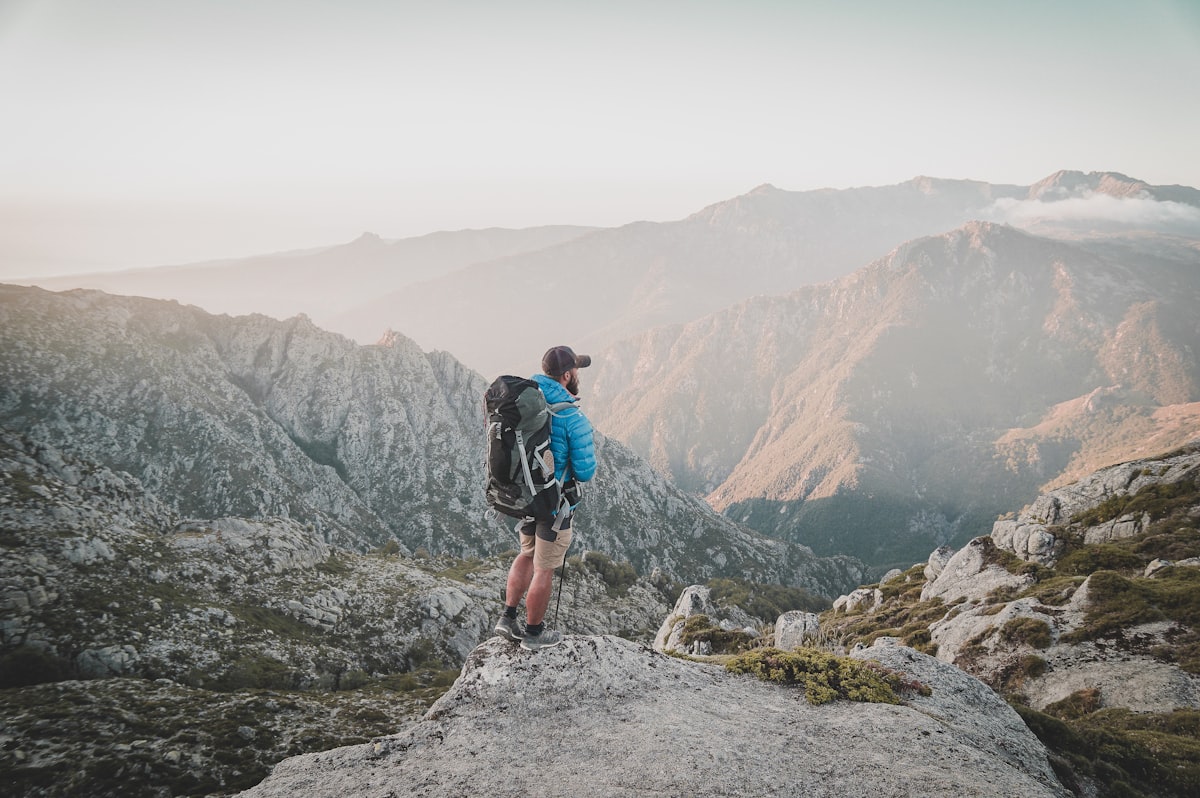 Hiker on mountain trail at dawn